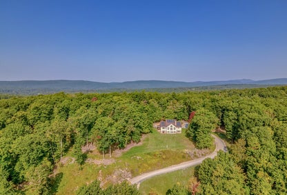 Aerial view of large estate home in forest, Accord, NY