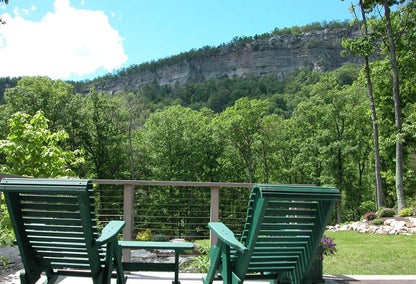 Chairs on home balcony overlooking mountains