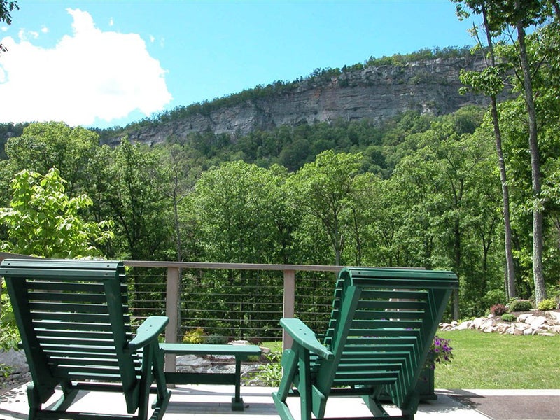 Chairs on home balcony overlooking mountains